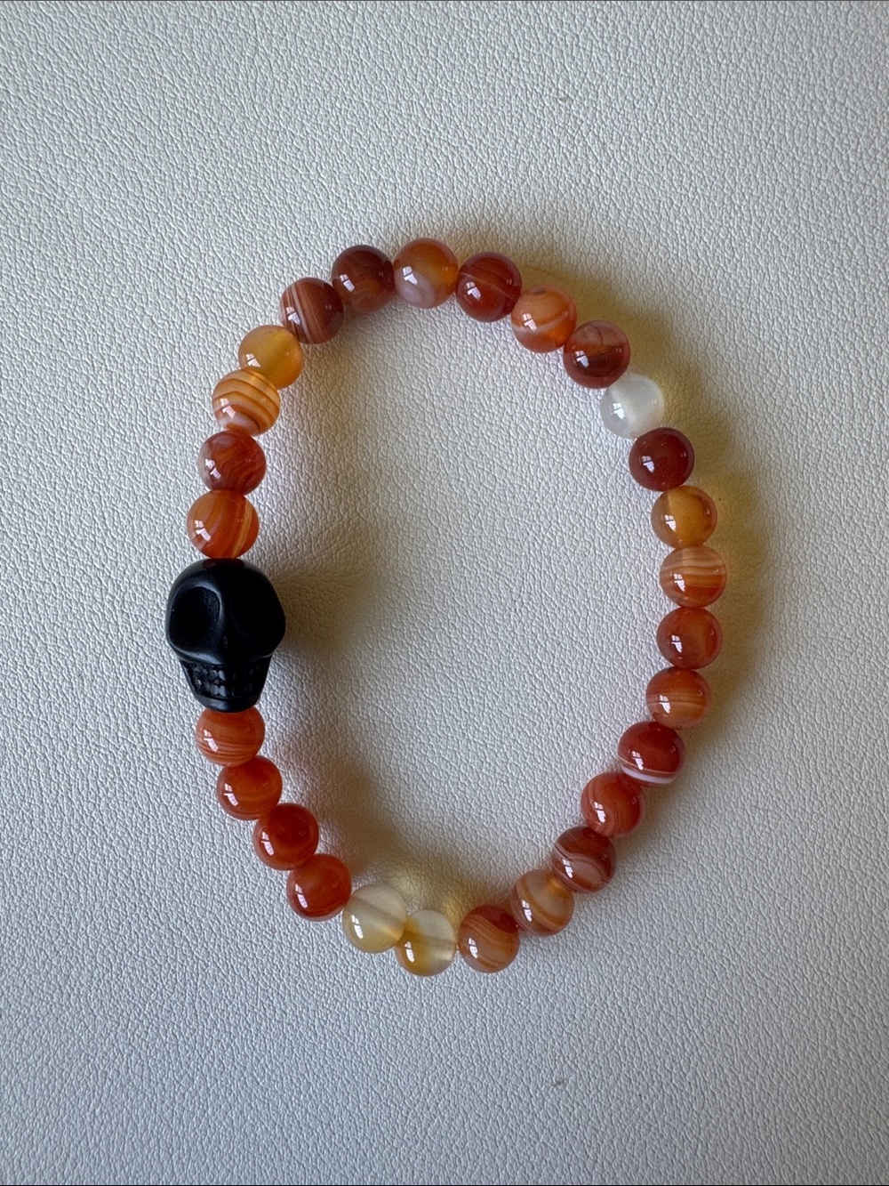 Beaded Carnelian Agate Bracelet with Black Skull Accent - Warm Orange Tones